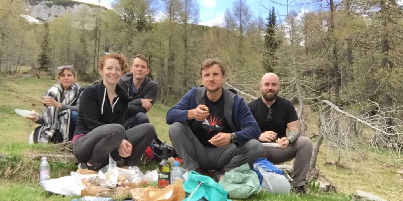 Friends having a picnic in the Slovenian Alps.