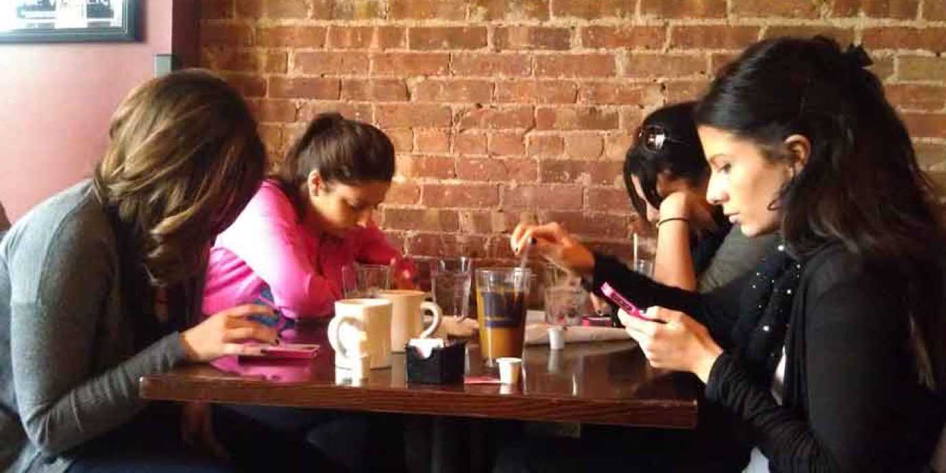 Ignoring friends at dinner on cell phones.