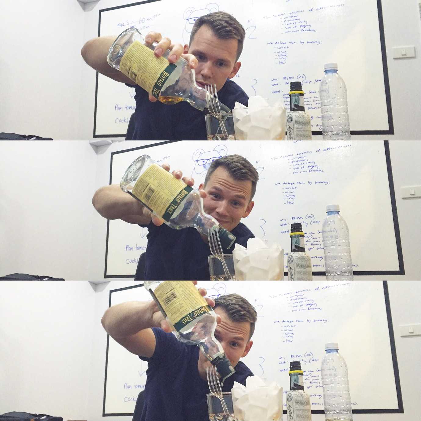 Nate Green pouring the last drops of a bottle of whiskey into his glass.